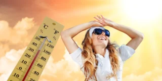 Вереснева хвиля спеки насувається. На фото: термометр, молода усміхнена жінка в сонцезахисних окулярах на тлі ясного неба в "золоту годину".